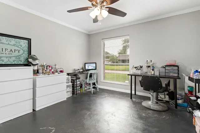 a view of a workspace with furniture and a window