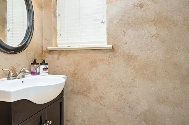 a bathroom with a sink a vanity and a mirror