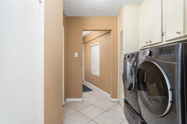 a view of a hallway with washer and dryer