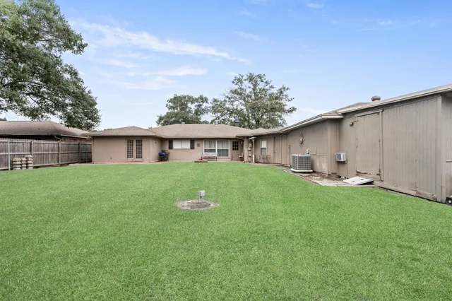 a front view of house with a garden and patio