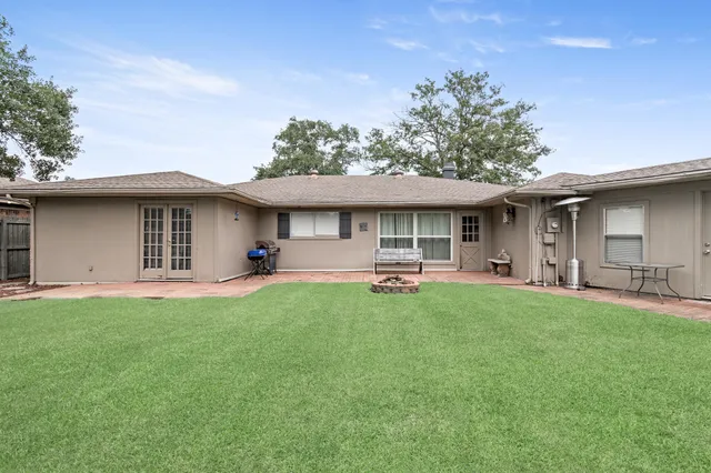 a view of a house with a yard and sitting area