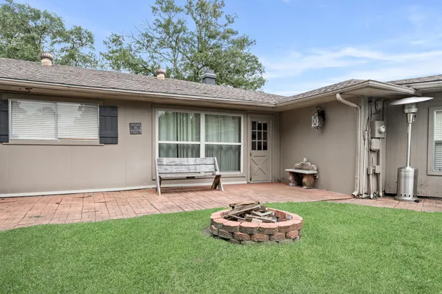 a backyard of a house with table and chairs