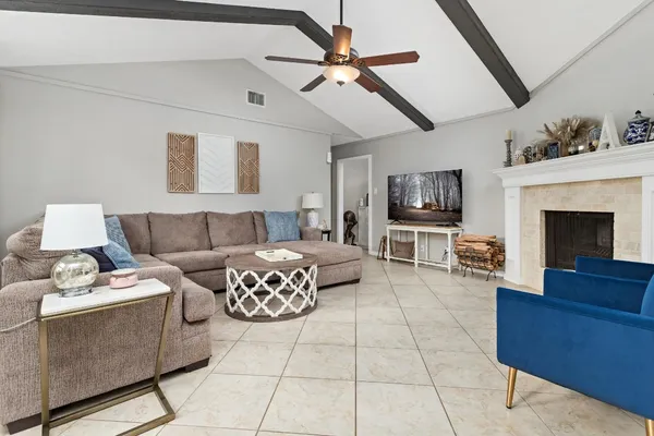 a living room with furniture and a fireplace