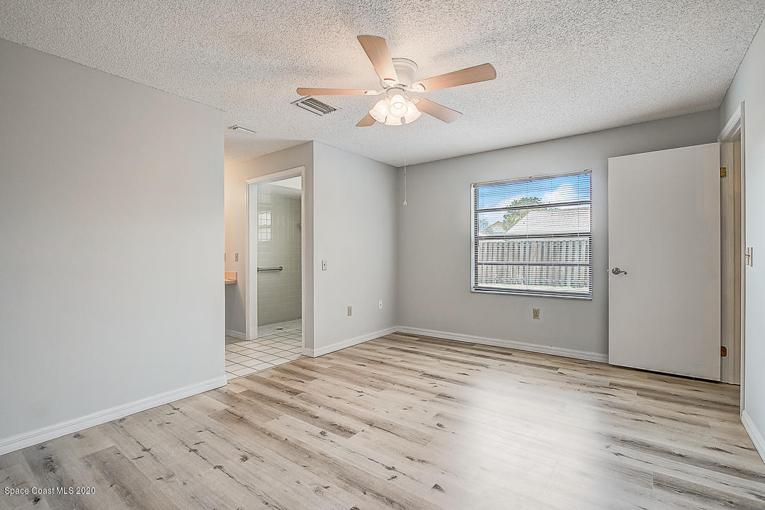 192 Cinnamon Bay Lane Melbourne, FL 32901 - Photo 16 of 34 wooden floor in an empty room with a window
