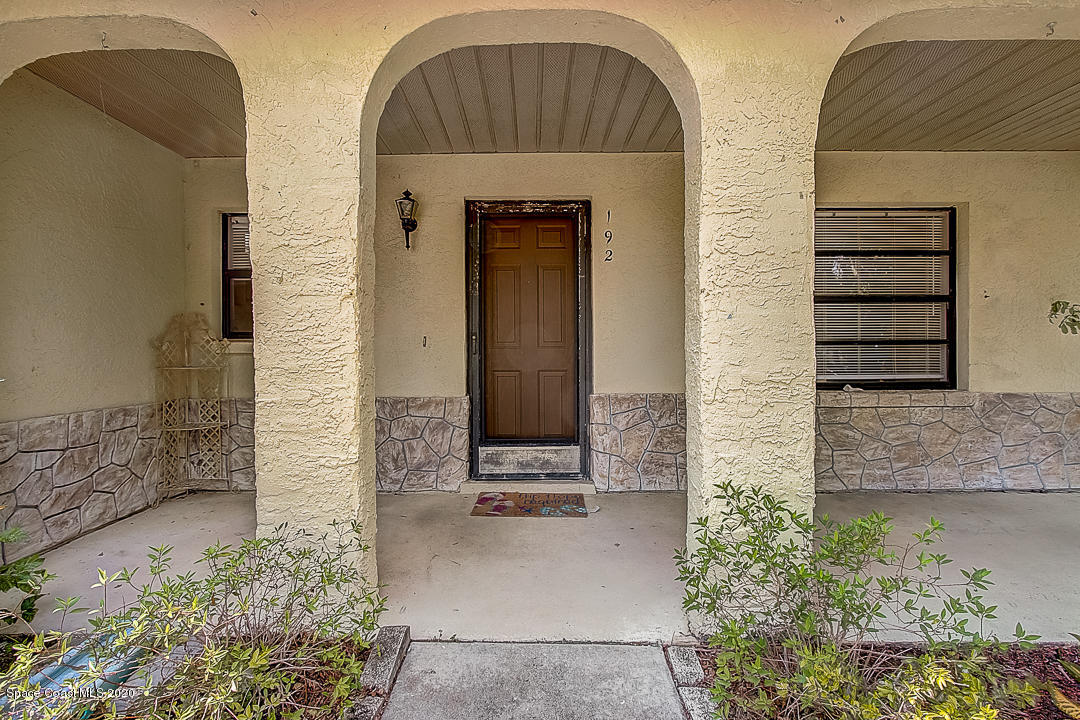 192 Cinnamon Bay Lane Melbourne, FL 32901 - Photo 3 of 34 a front view of a house with a garden