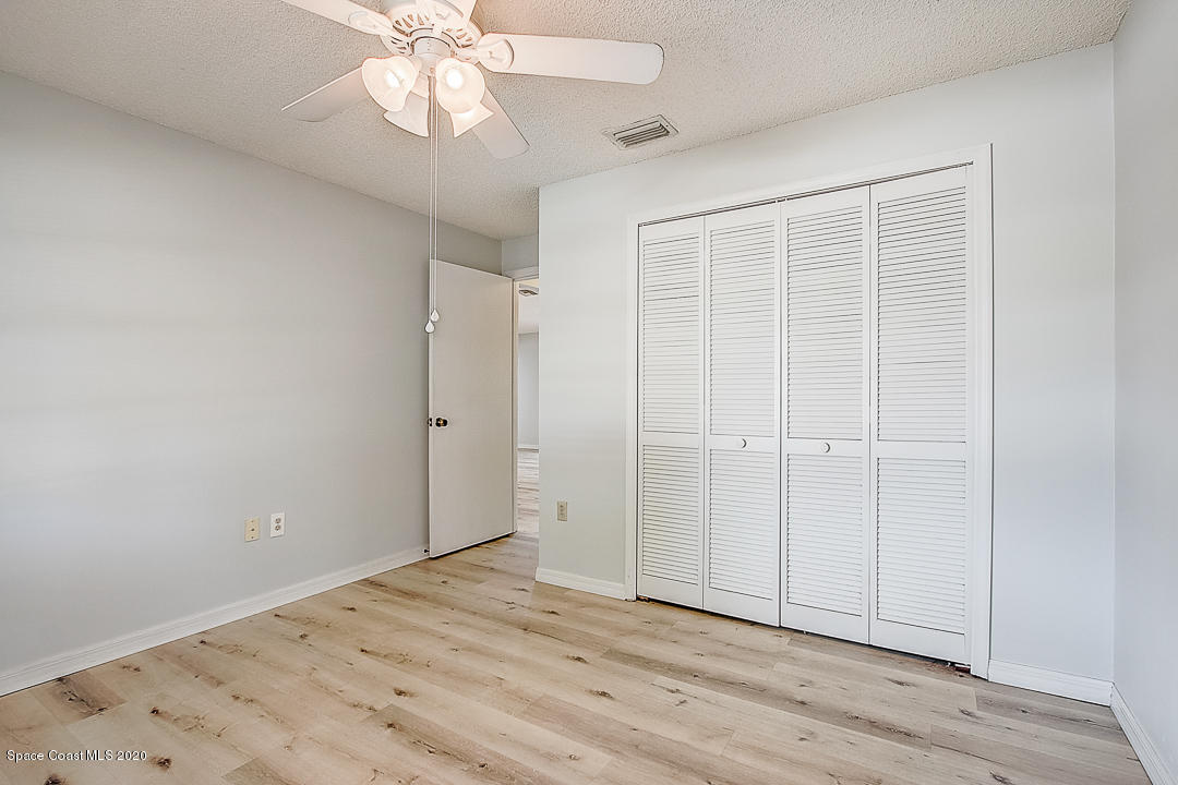 192 Cinnamon Bay Lane Melbourne, FL 32901 - Photo 23 of 34 wooden floor in an empty room with a window