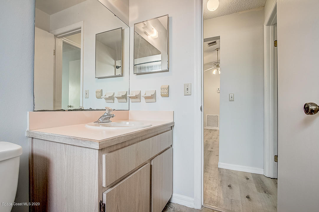 192 Cinnamon Bay Lane Melbourne, FL 32901 - Photo 25 of 34 a bathroom with a sink a toilet and a mirror