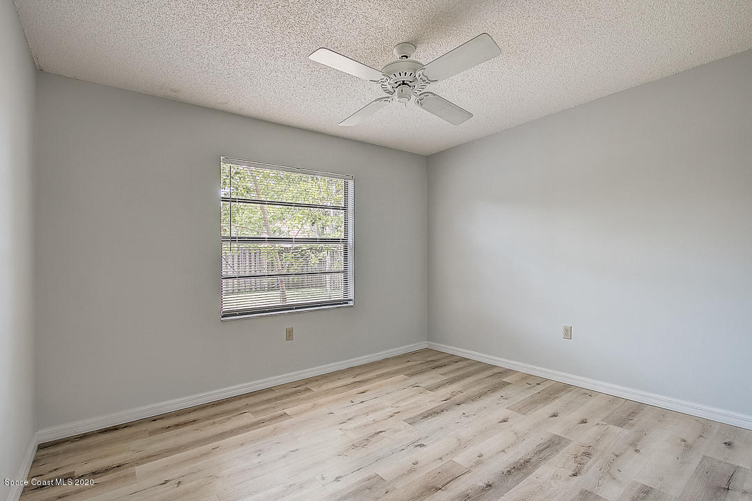 192 Cinnamon Bay Lane Melbourne, FL 32901 - Photo 26 of 34 wooden floor in an empty room with a window