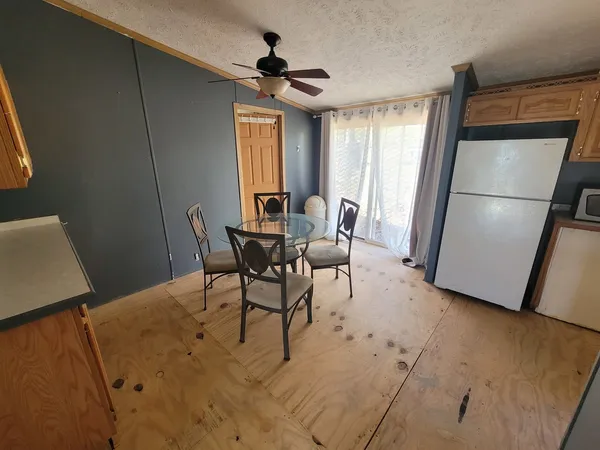 a view of a dining room with furniture and a window