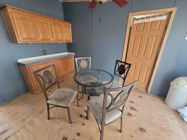 a view of a chair and table in kitchen