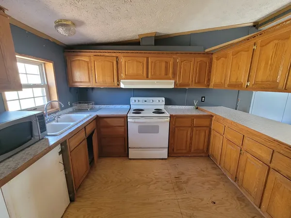 a kitchen with a sink stove and cabinets