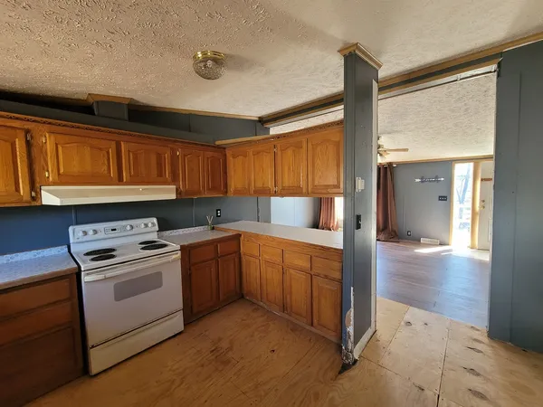 a kitchen with a stove a sink and a refrigerator