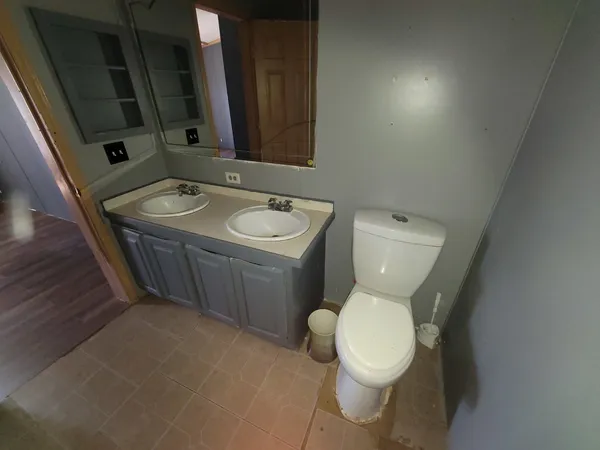 a white toilet sitting next to a bathroom sink