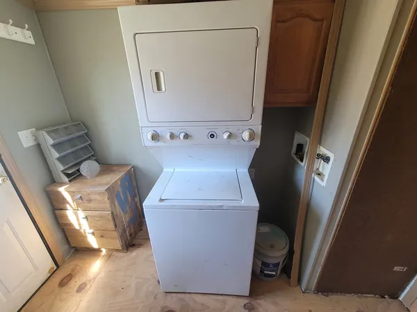 a view of a storage and utility room with a washer dryer