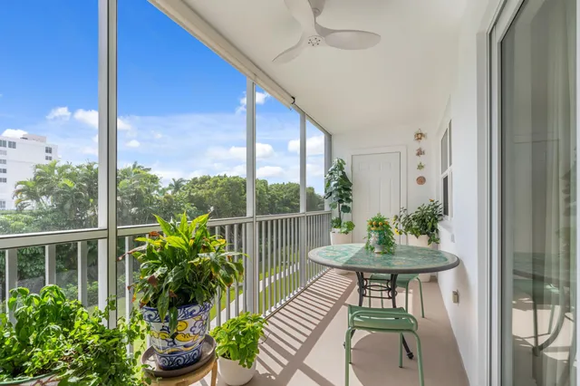 a view of a porch with a table and chairs