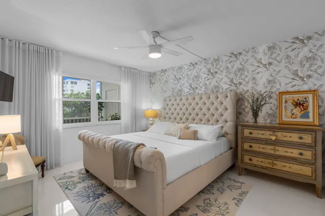 a bedroom with a bed dresser and window