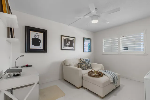 a white couch sitting in a room next to a window