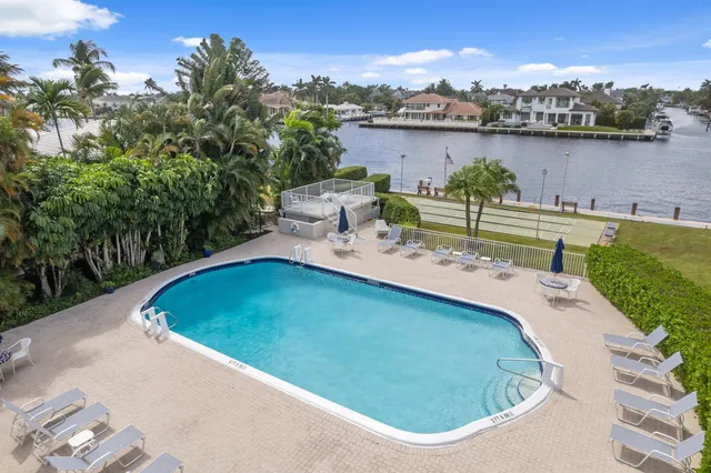a view of a swimming pool with an outdoor seating and a garden