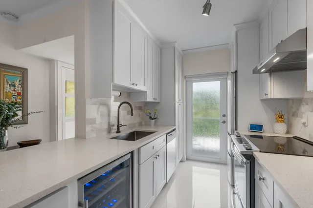 a kitchen with a sink and a refrigerator