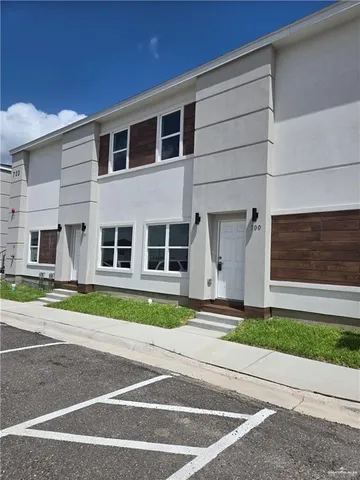 a front view of a house with a garden and yard