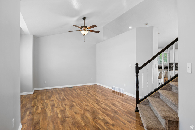 142 East 2675th Street South Clearfield, UT 84015 - Photo 5 of 49 Spacious living area featuring wood-finish flooring, vaulted ceilings, and a ceiling fan with integrated lighting