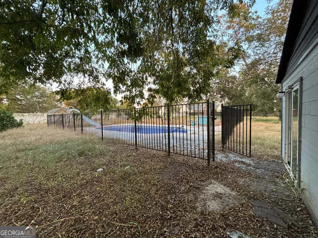 a view of a backyard with large trees