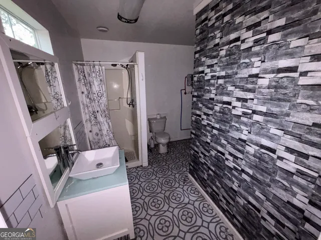 a bathroom with a sink toilet and shower