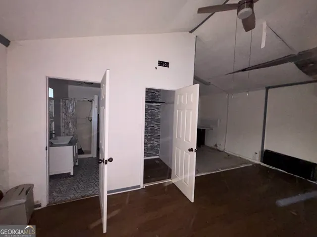 a view of a hallway with entryway with wooden floor