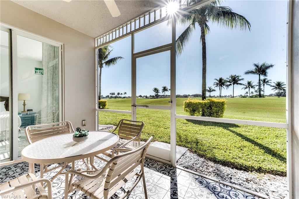7955 Mahogany Run Lane, Unit 514 Naples, FL 34113 - Photo 16 of 30 a view of a swimming pool with a lawn chairs and a dining table