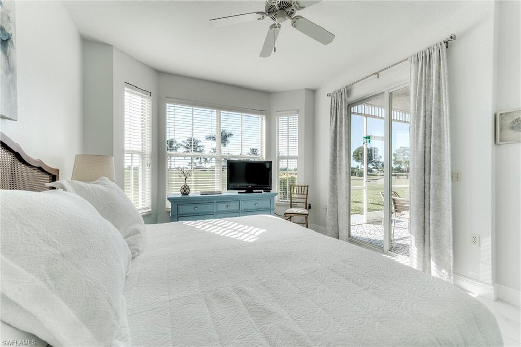 7955 Mahogany Run Lane, Unit 514 Naples, FL 34113 - Photo 20 of 30 a bedroom with a bed and a fireplace