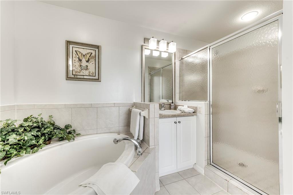 7955 Mahogany Run Lane, Unit 514 Naples, FL 34113 - Photo 24 of 30 a bathroom with a bathtub and shower