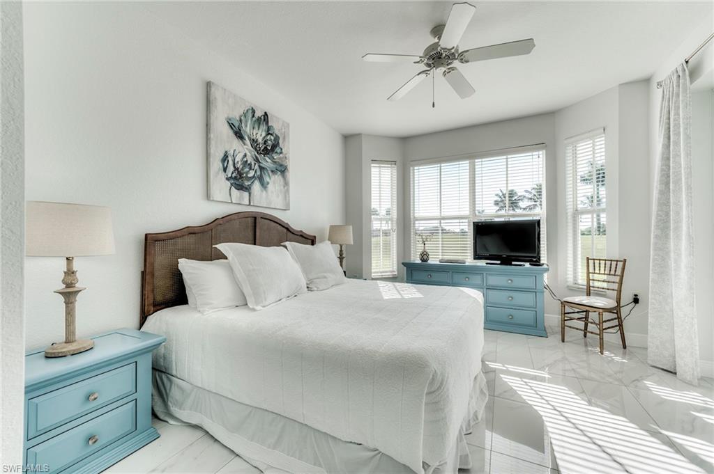 7955 Mahogany Run Lane, Unit 514 Naples, FL 34113 - Photo 25 of 30 a bedroom with a bed and a television