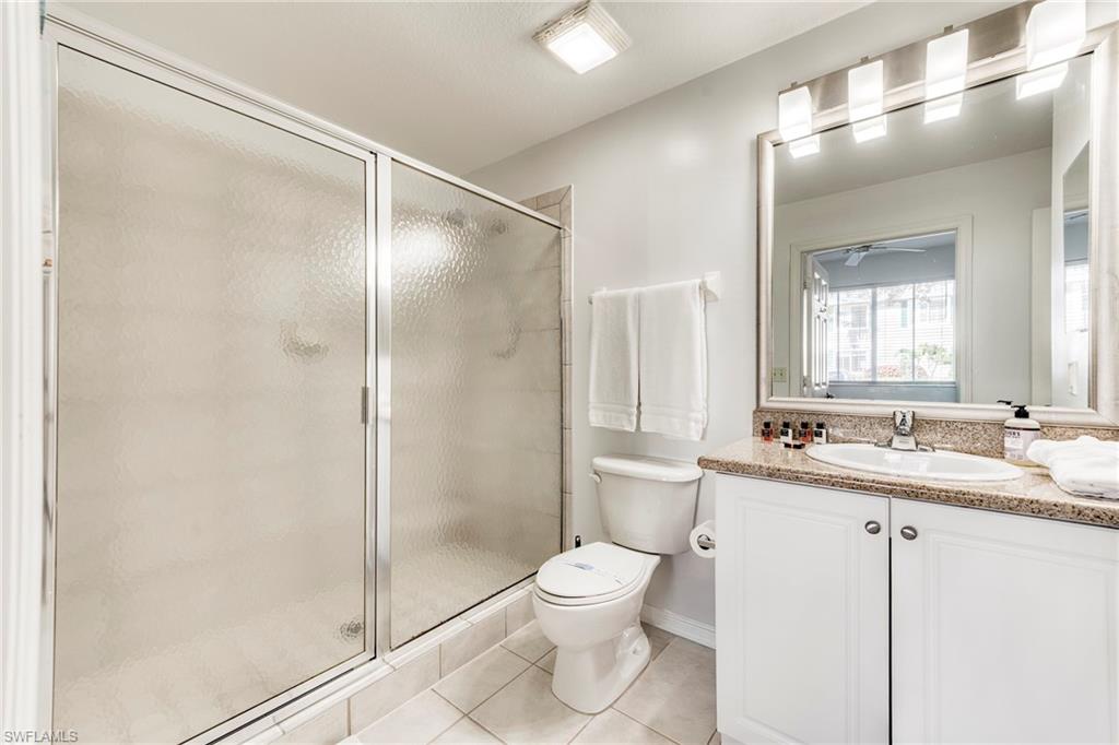 7955 Mahogany Run Lane, Unit 514 Naples, FL 34113 - Photo 28 of 30 a bathroom with a toilet sink and shower