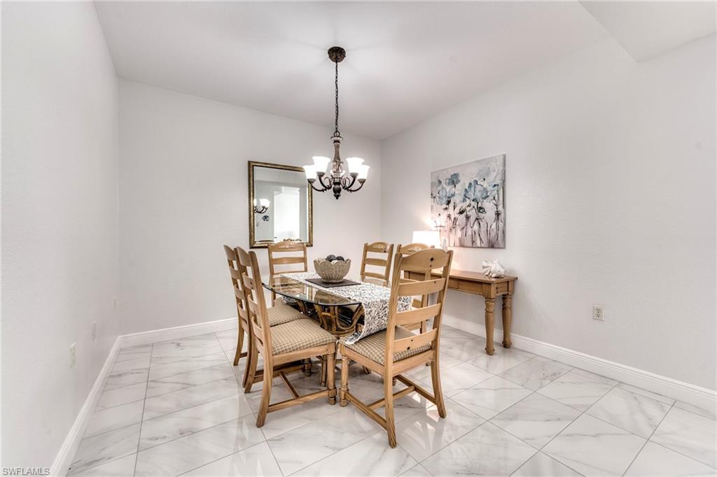 7955 Mahogany Run Lane, Unit 514 Naples, FL 34113 - Photo 30 of 30 a dining room with furniture and window