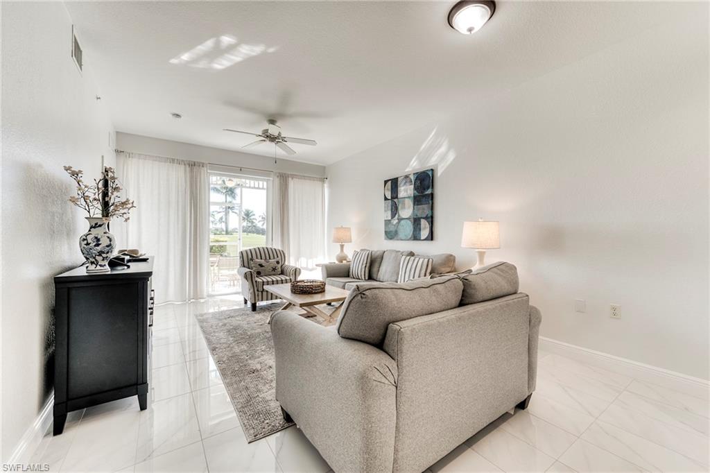 7955 Mahogany Run Lane, Unit 514 Naples, FL 34113 - Photo 6 of 30 a living room with furniture and a large window