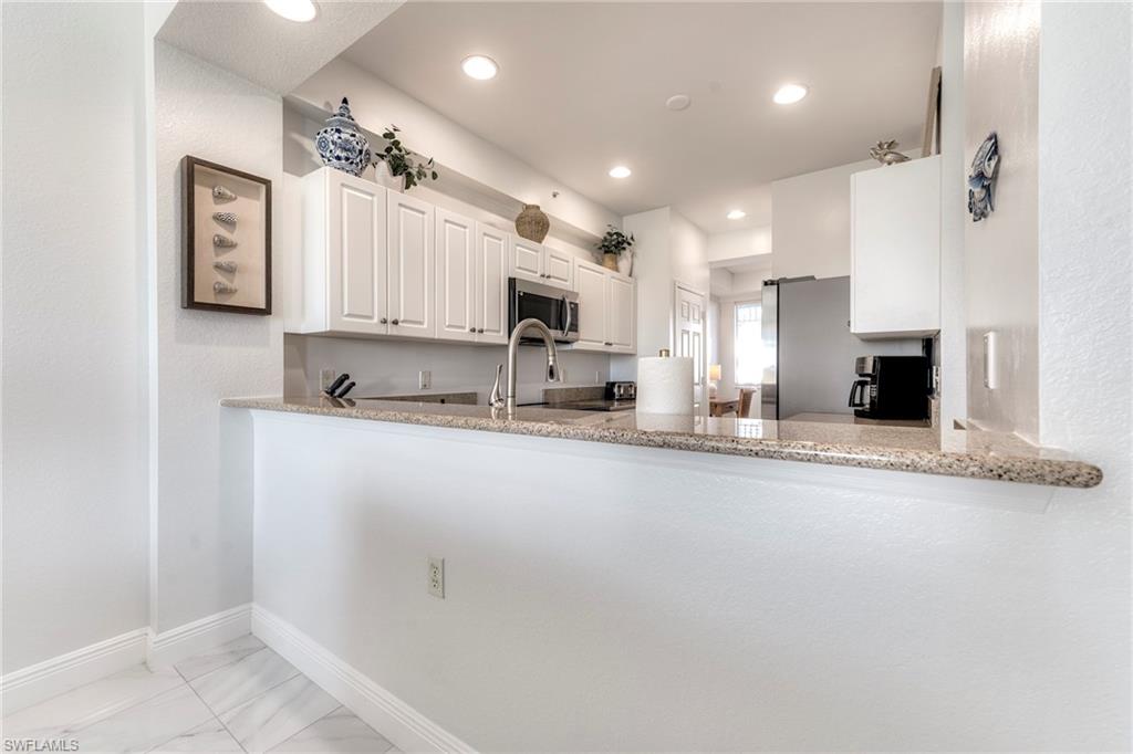 7955 Mahogany Run Lane, Unit 514 Naples, FL 34113 - Photo 9 of 30 a view of kitchen with sink and refrigerator