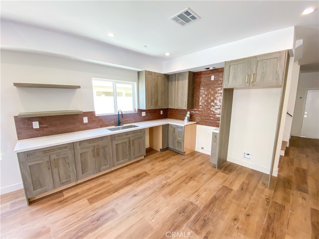 a kitchen with a sink cabinets and window