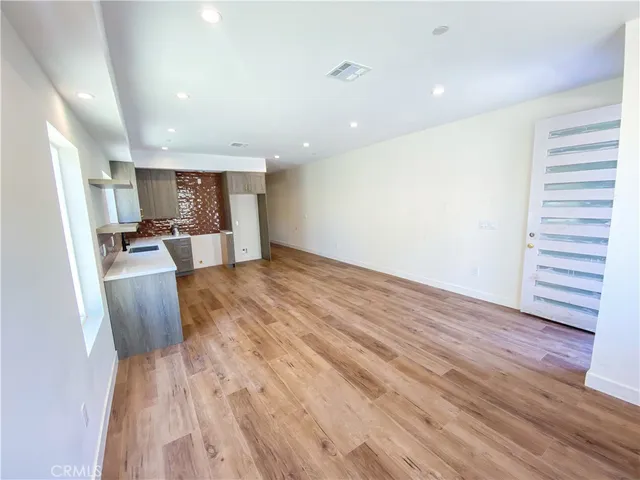 a view of kitchen with cabinets and wooden floor