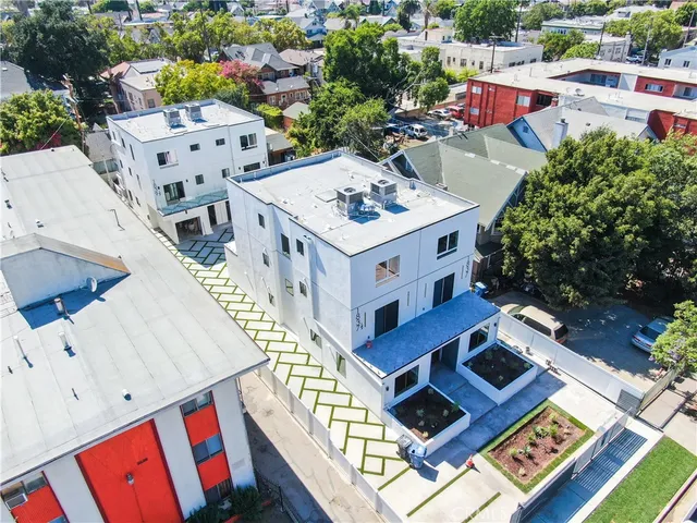 an aerial view of a house with pool garden and outdoor seating