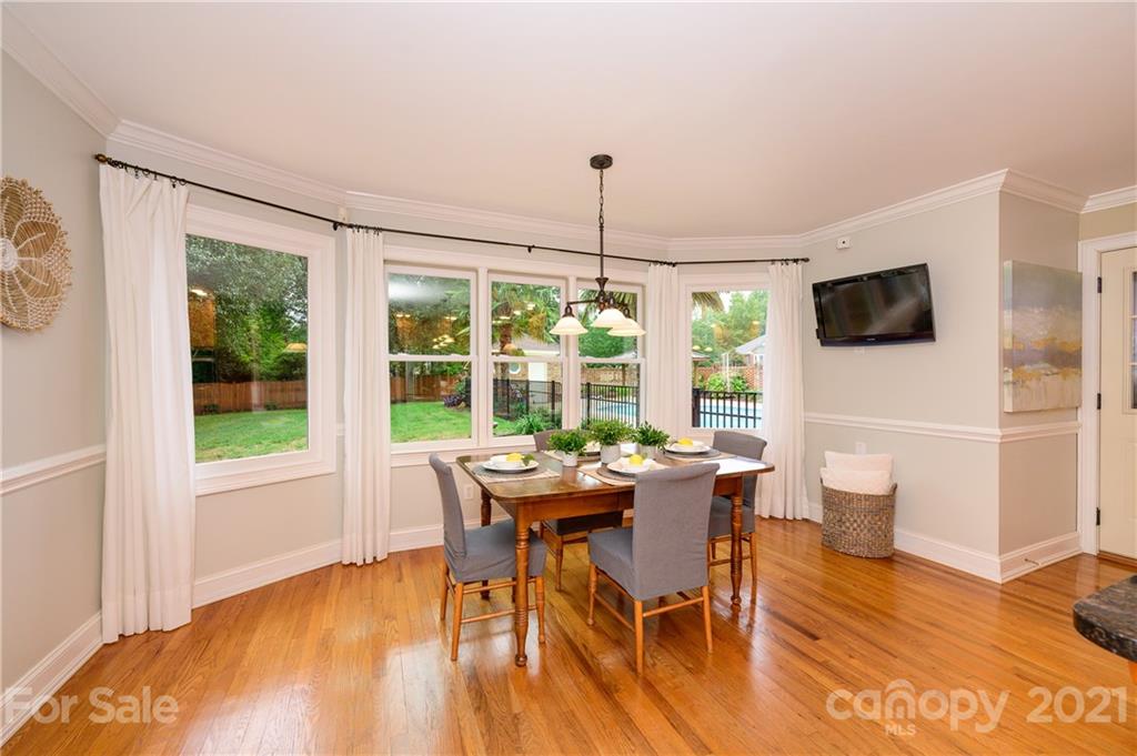 8456 Fairfield Forest Road Denver, NC 28037 - Photo 13 of 38 a dining room with furniture large windows and wooden floor