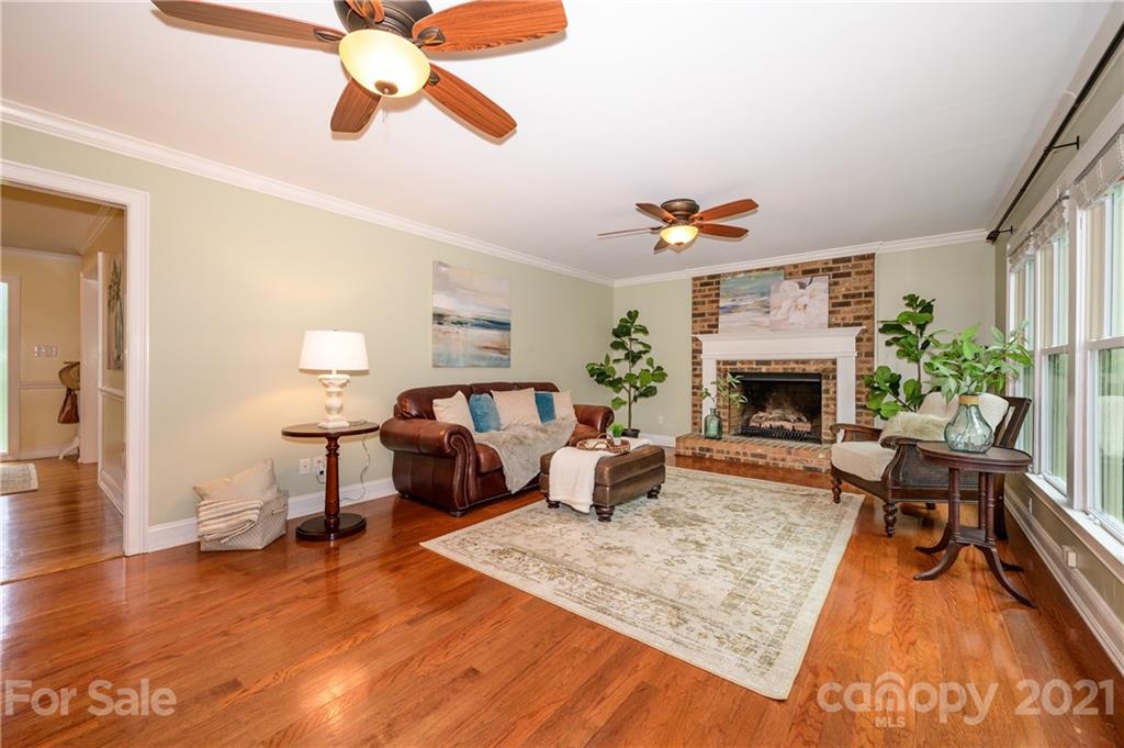 8456 Fairfield Forest Road Denver, NC 28037 - Photo 15 of 38 a living room with furniture and a fireplace