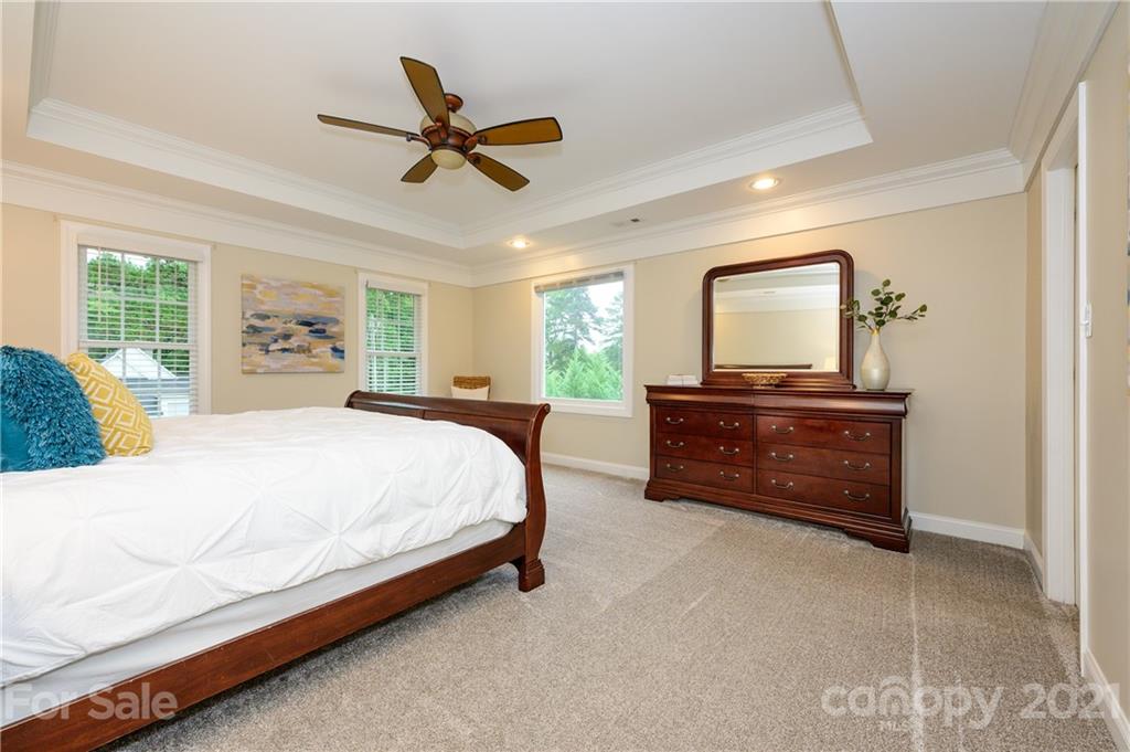 8456 Fairfield Forest Road Denver, NC 28037 - Photo 19 of 38 a spacious bedroom with a bed a dresser and a large window