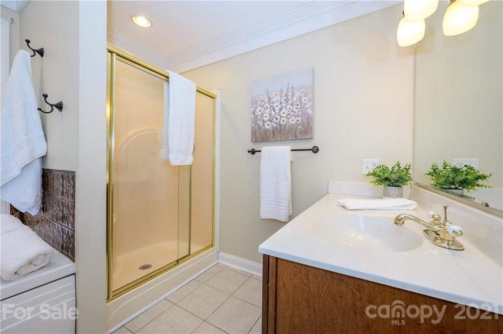 8456 Fairfield Forest Road Denver, NC 28037 - Photo 22 of 38 a bath room with a sink and a mirror