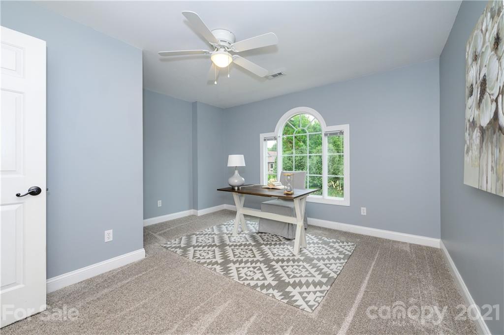 8456 Fairfield Forest Road Denver, NC 28037 - Photo 25 of 38 a living room with a window and a table