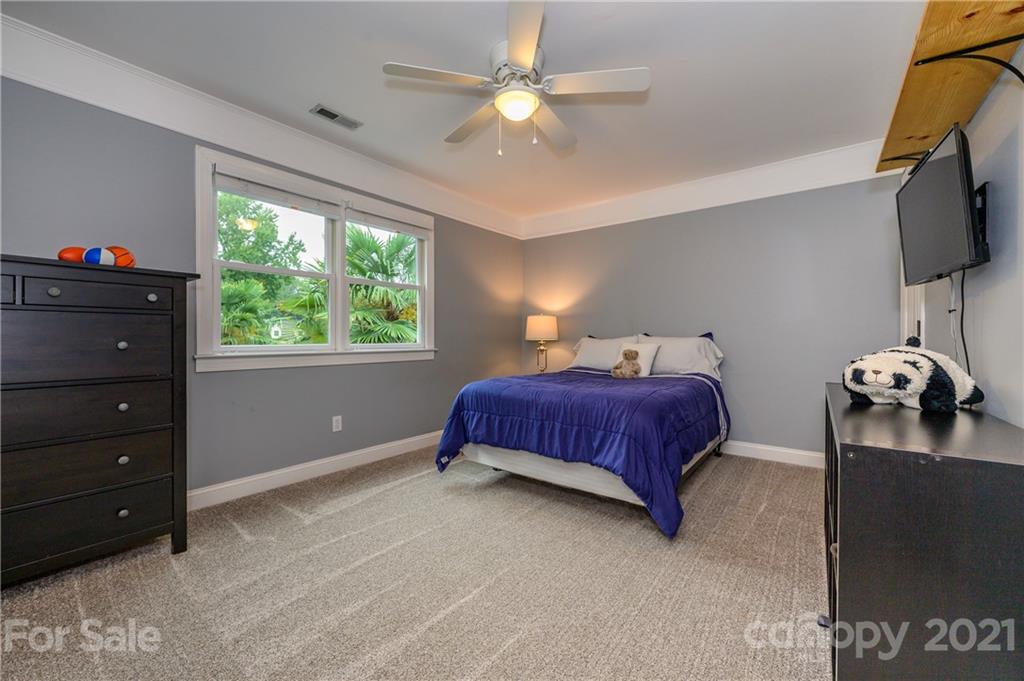 8456 Fairfield Forest Road Denver, NC 28037 - Photo 26 of 38 a bedroom with a bed and a tv
