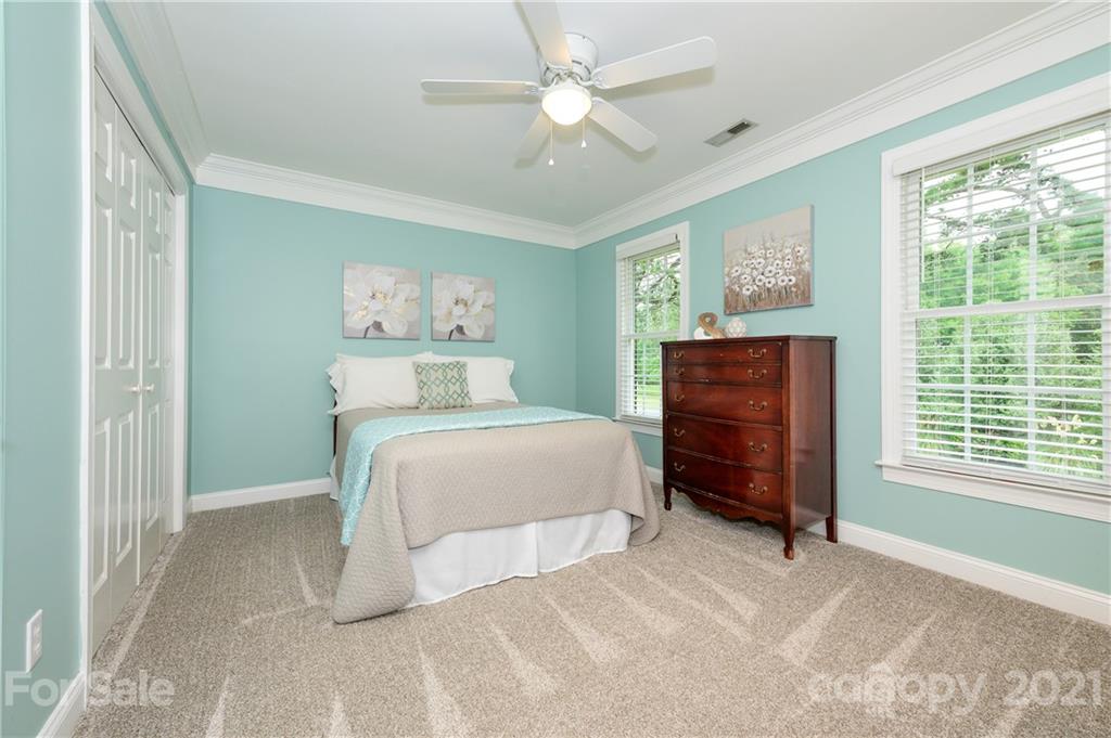 8456 Fairfield Forest Road Denver, NC 28037 - Photo 29 of 38 a bedroom with a bed dresser and a window
