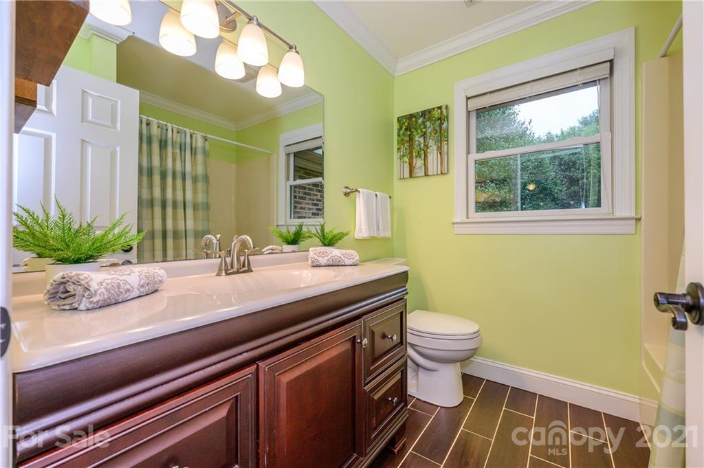 8456 Fairfield Forest Road Denver, NC 28037 - Photo 30 of 38 a bathroom with a granite countertop bathtub sink vanity mirror and toilet