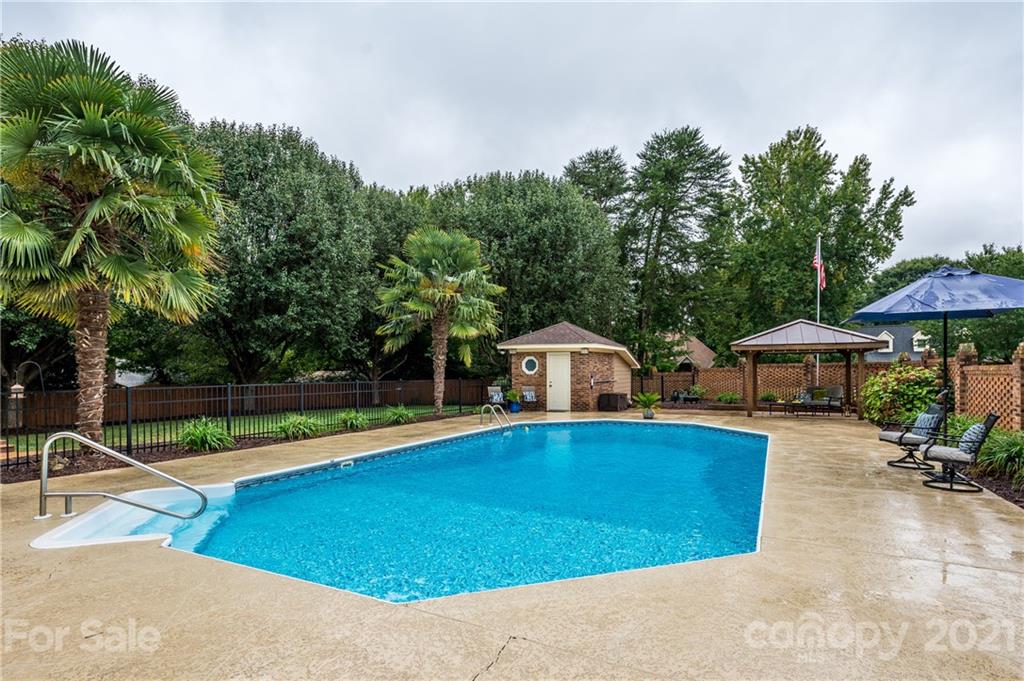 8456 Fairfield Forest Road Denver, NC 28037 - Photo 32 of 38 swimming pool view with a seating space and a garden view
