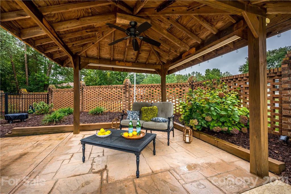 8456 Fairfield Forest Road Denver, NC 28037 - Photo 34 of 38 a roof deck with a table and chairs and potted plants