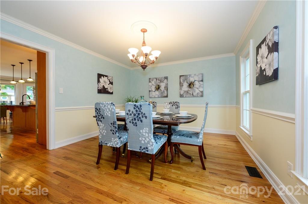 8456 Fairfield Forest Road Denver, NC 28037 - Photo 6 of 38 a view of a dining room with furniture wooden floor and a chandelier